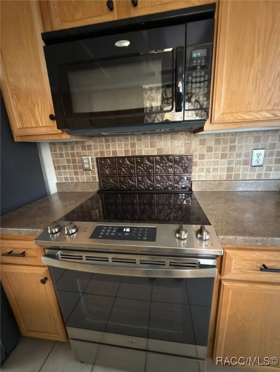 kitchen with decorative backsplash and stainless steel range with electric cooktop