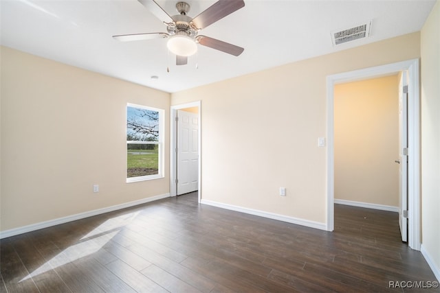 empty room featuring ceiling fan and dark wood-type flooring