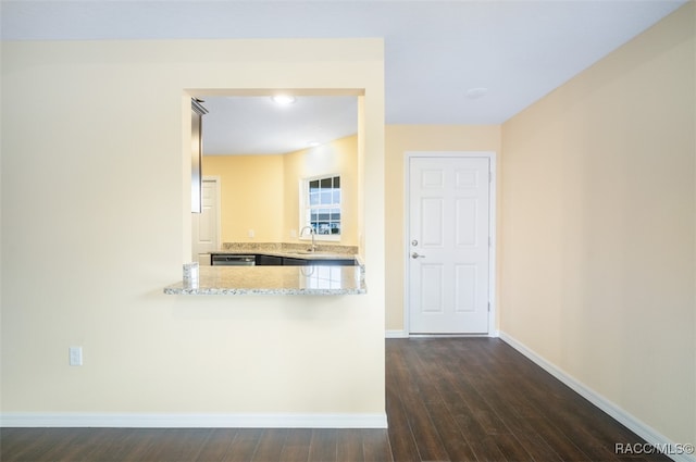 hallway featuring dark wood-type flooring and sink