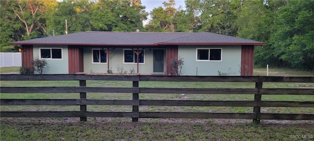 ranch-style house featuring roof with shingles