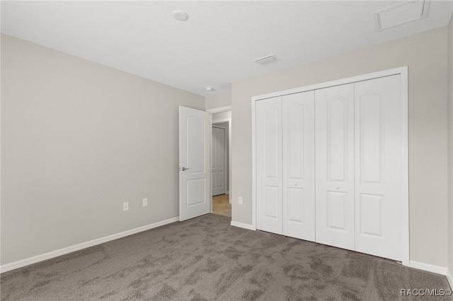 unfurnished bedroom featuring carpet floors and a closet