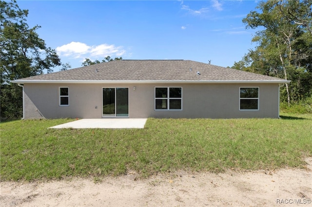 rear view of property featuring a yard and a patio