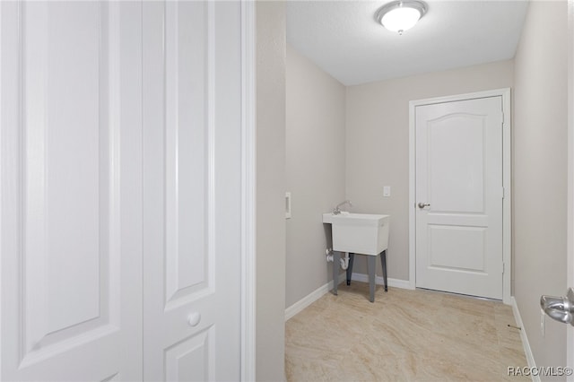 laundry room featuring a textured ceiling