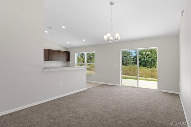 unfurnished room featuring light carpet, vaulted ceiling, and a notable chandelier