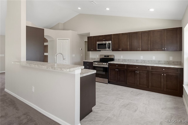 kitchen featuring light carpet, dark brown cabinets, high vaulted ceiling, and stainless steel appliances