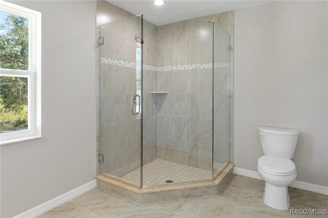 bathroom with tile patterned flooring, a shower with shower door, and toilet