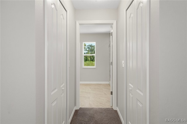 hallway with light carpet