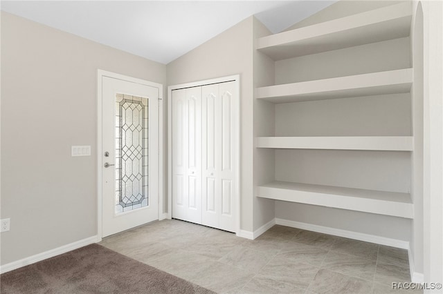 entryway with vaulted ceiling