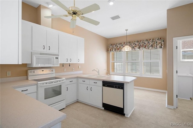 kitchen featuring white appliances, sink, kitchen peninsula, hanging light fixtures, and white cabinetry