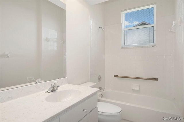 full bathroom with vanity, tiled shower / bath combo, and toilet