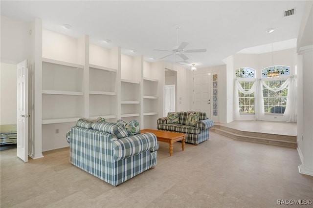 living room with ceiling fan and built in features