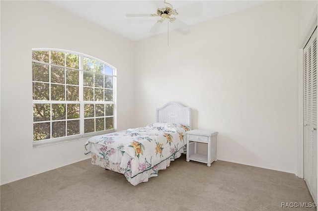 bedroom featuring a closet, ceiling fan, and light colored carpet