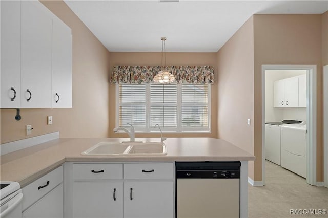 kitchen featuring dishwasher, sink, pendant lighting, white cabinets, and washer and dryer