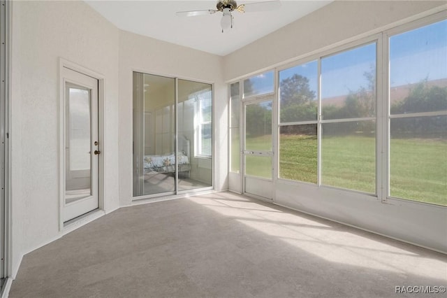 unfurnished sunroom with ceiling fan