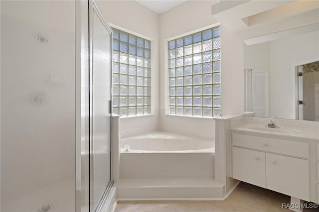 bathroom featuring tile patterned floors, vanity, and separate shower and tub