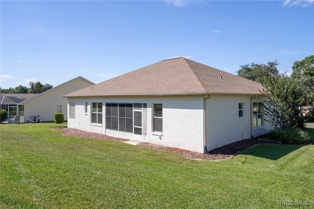 rear view of property featuring a yard