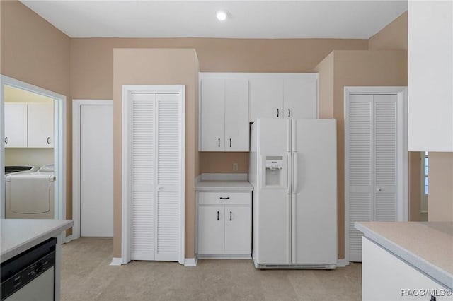 kitchen with white cabinetry, white fridge with ice dispenser, dishwasher, and washer and dryer