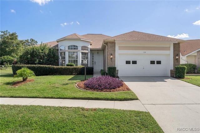 view of front of house with a garage and a front yard