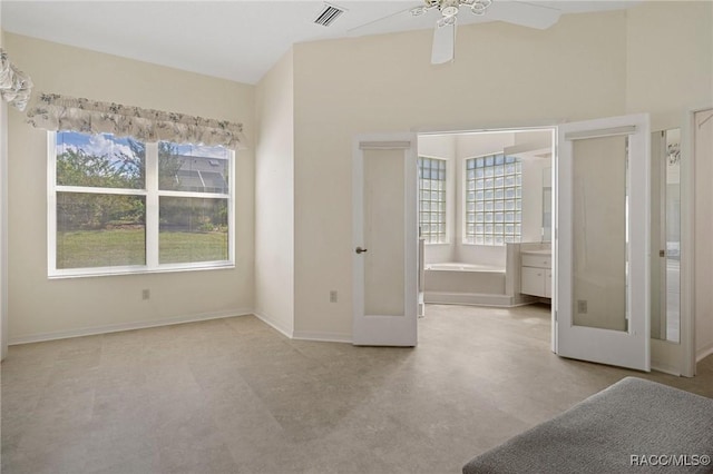 unfurnished bedroom featuring connected bathroom, ceiling fan, and french doors