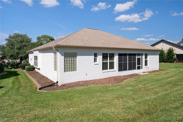 rear view of house with a lawn