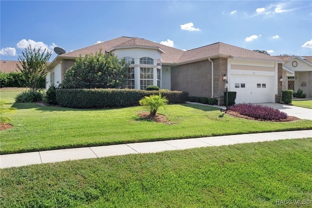 view of front of property with a front yard and a garage