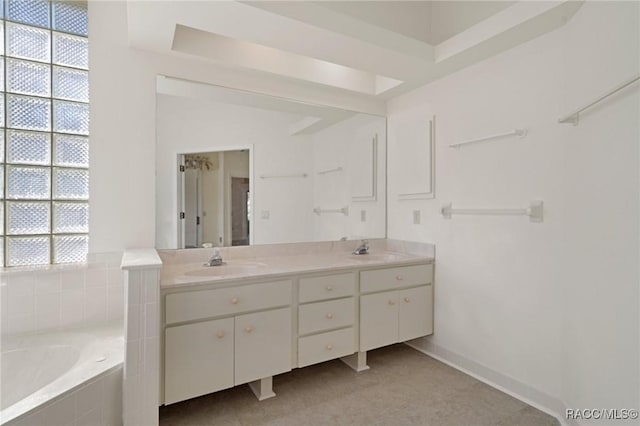 bathroom featuring vanity and a relaxing tiled tub