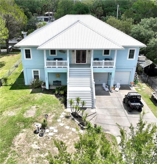 back of property featuring a garage, a balcony, and a yard