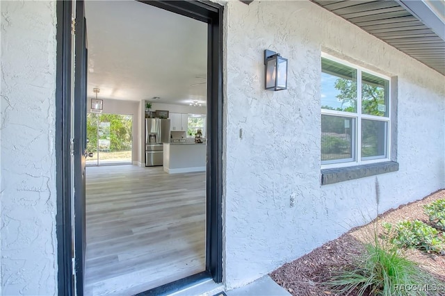 entrance to property featuring stucco siding