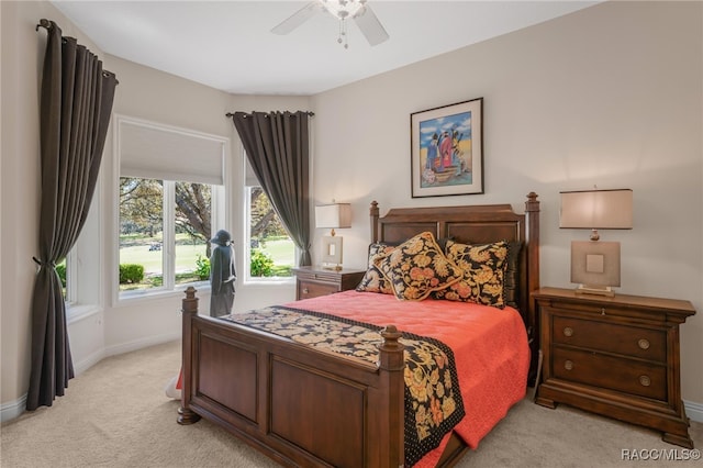 bedroom with baseboards, light colored carpet, and a ceiling fan