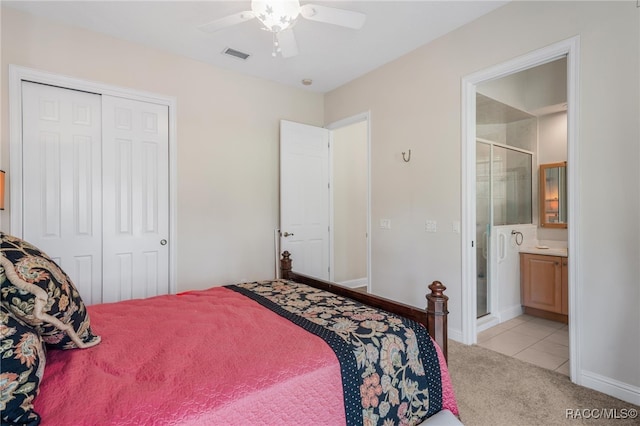 bedroom featuring visible vents, connected bathroom, ceiling fan, light carpet, and a closet