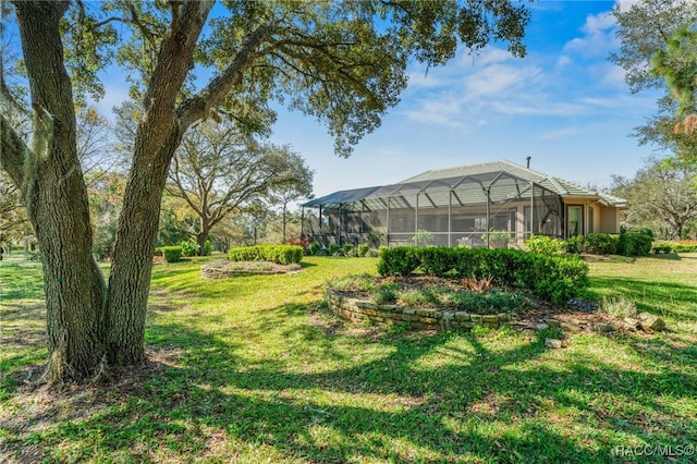 view of yard featuring glass enclosure