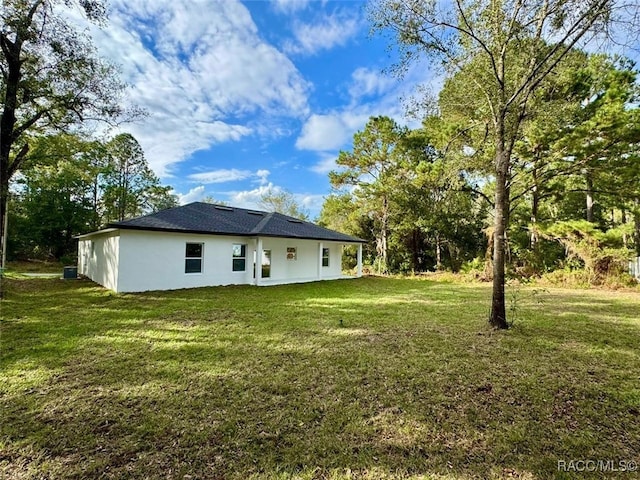 rear view of property with a yard