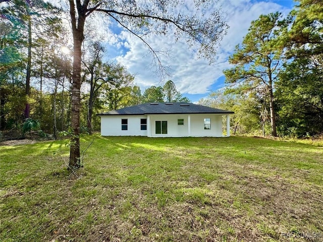 back of house with a lawn