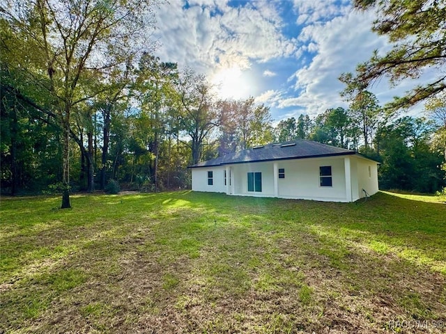 back of house with a yard