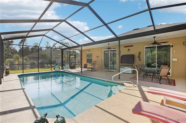 view of swimming pool featuring a patio, a lanai, and ceiling fan