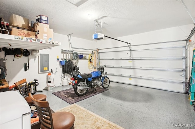 garage with a garage door opener and electric panel