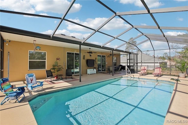 view of pool featuring ceiling fan, a patio area, and glass enclosure