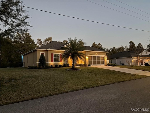 view of front of house with a garage and a front lawn