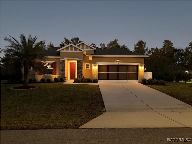 view of front of house with a yard and a garage