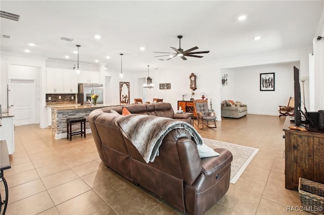 tiled living room with ceiling fan