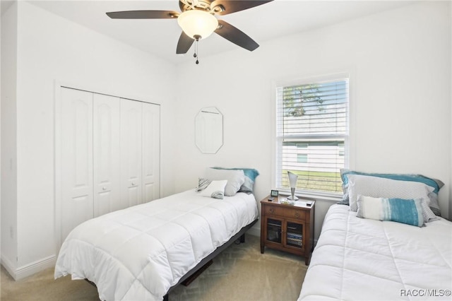 bedroom with a closet, ceiling fan, and carpet