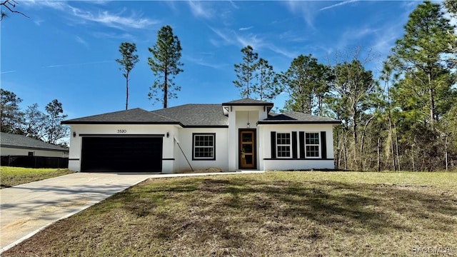 view of front of property with a garage, a front yard, concrete driveway, and stucco siding