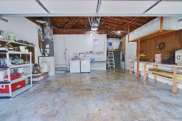 garage featuring independent washer and dryer, heating unit, and a garage door opener