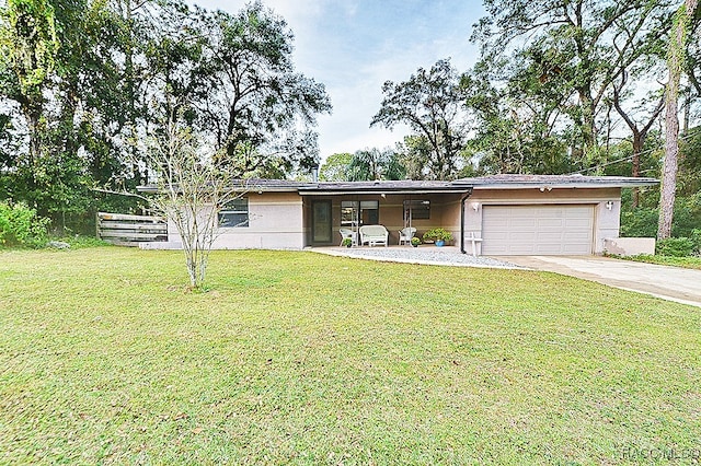 ranch-style house with a garage and a front lawn