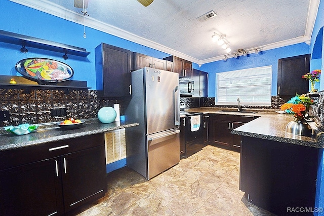 kitchen with decorative backsplash, electric range oven, stainless steel refrigerator, and sink