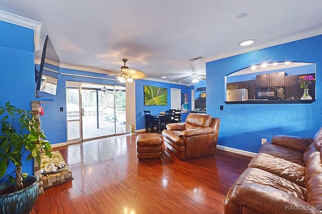 living room featuring crown molding and dark wood-type flooring