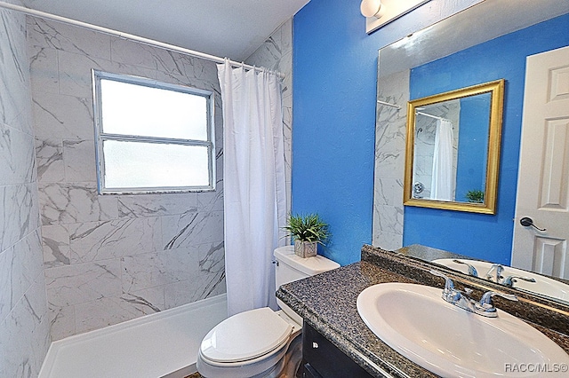 bathroom with vanity, toilet, and curtained shower