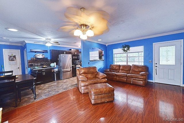 living room with ornamental molding, a textured ceiling, ceiling fan, and dark wood-type flooring