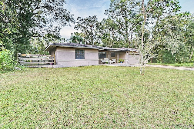 view of front facade with a front yard and a garage