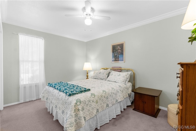 carpeted bedroom with ceiling fan and crown molding